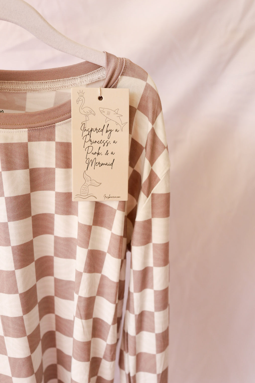 Checkered shirt with a tag on a plain background
